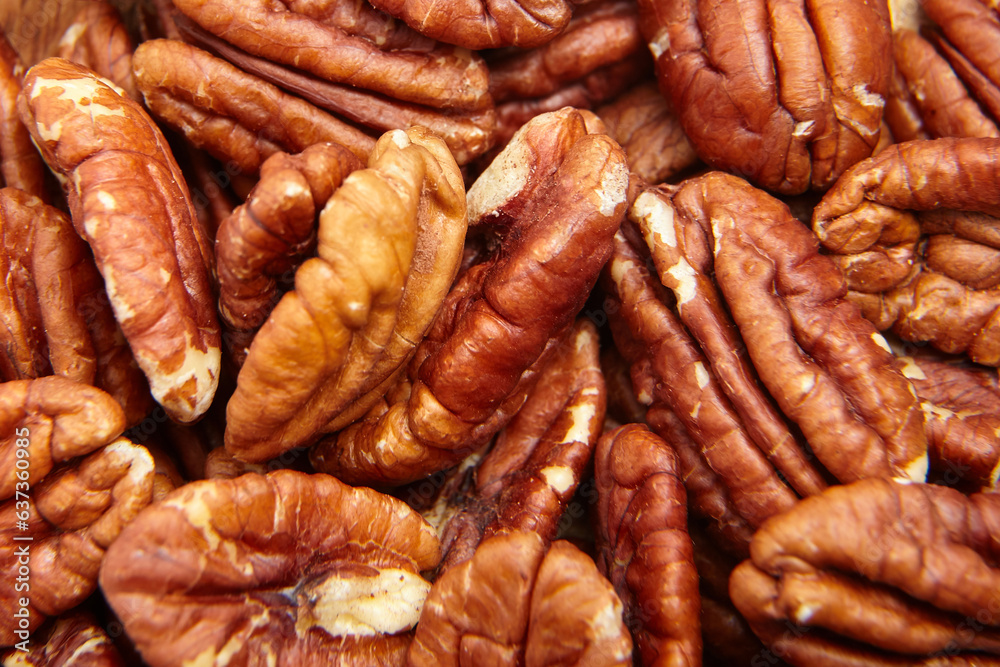 Pecan nuts kernel texture background closeup. Heap of peeled pecan halves. A rich harvest of peeled pecan nuts Pecan nuts kernel texture background closeup. Heap of peeled pecan halves. A rich harvest of peeled pecan nuts
