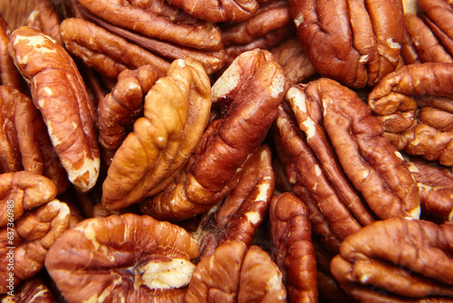 Pecan nuts kernel texture background closeup. Heap of peeled pecan halves. A rich harvest of peeled pecan nuts