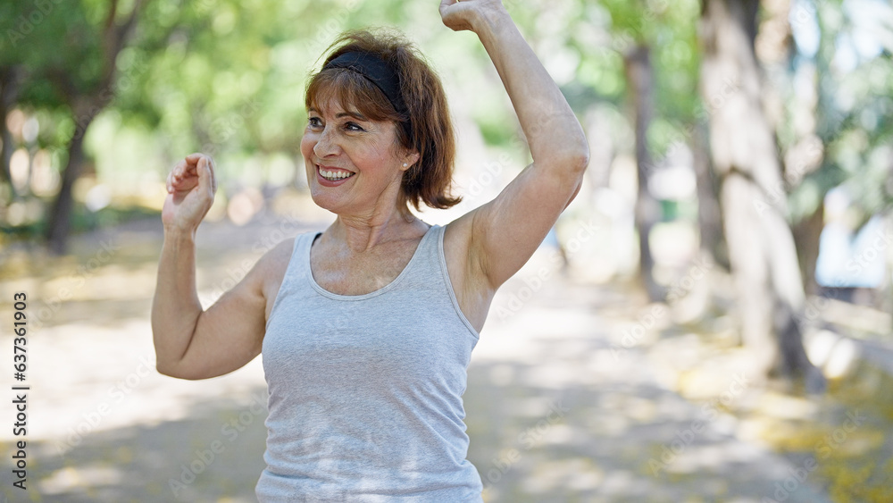 Middle age woman wearing sportswear dancing at park Middle age woman wearing sportswear dancing at park