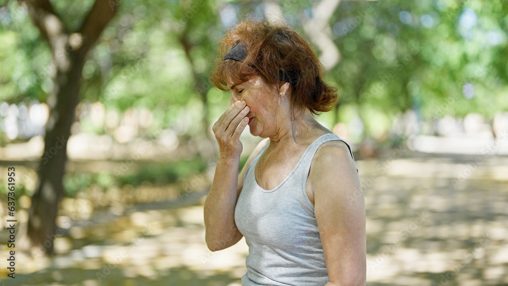 Middle age woman with pollen allergy at park Middle age woman with pollen allergy at park