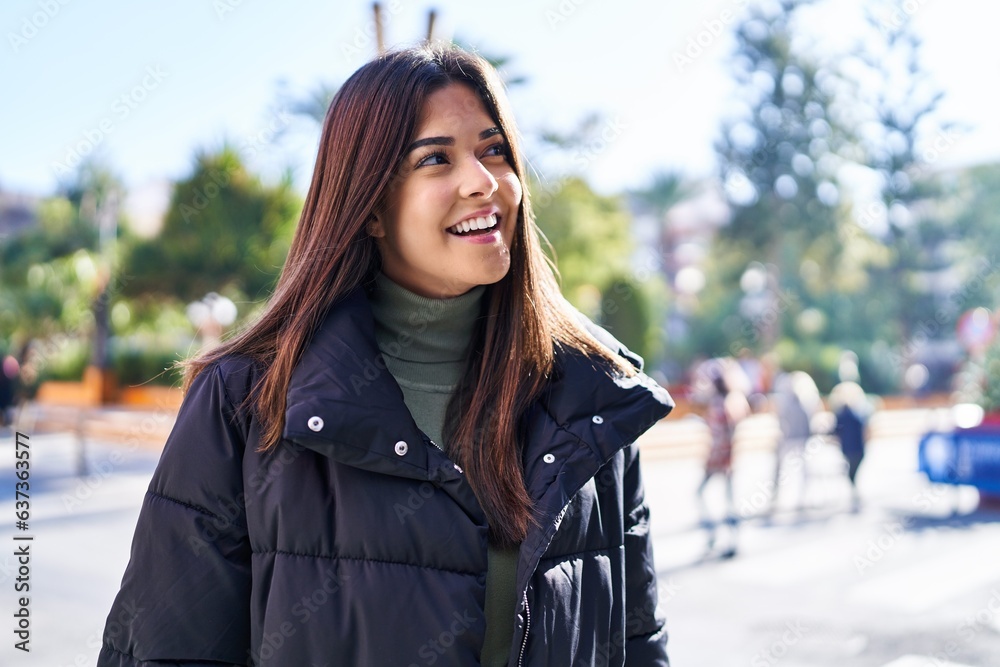 Young beautiful hispanic woman smiling confident looking to the side at street Young beautiful hispanic woman smiling confident looking to the side at street