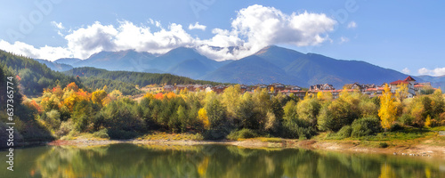 Bansko, Bulgaria autumn banner panorama background of Pirin mountain peaks, Krinets lake water, colorful green, red and yellow trees reflection photo
