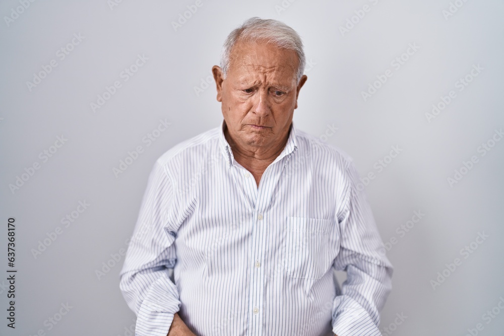 Senior man with grey hair standing over isolated background depressed and worry for distress, crying angry and afraid. sad expression. Senior man with grey hair standing over isolated background depressed and worry for distress, crying angry and afraid. sad expression.