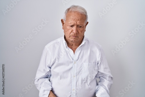 Senior man with grey hair standing over isolated background depressed and worry for distress, crying angry and afraid. sad expression.