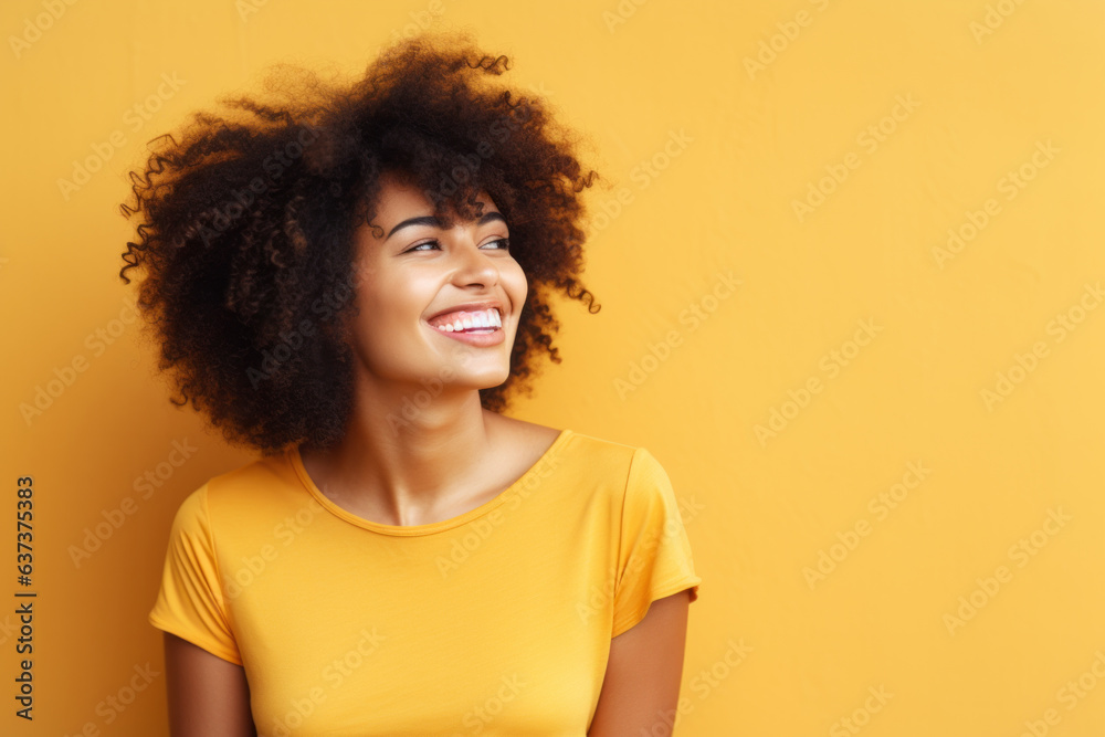 Beautiful woman with afro hair smiling on bright yellow background, smiling portrait Beautiful woman with afro hair smiling on bright yellow background, smiling portrait