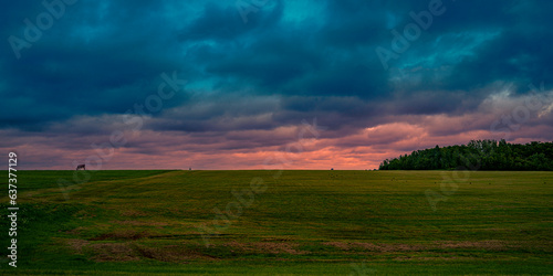 Dramatic stormy sunset hilly roadside landscape on the TranceCanada Highway of Route 2 at Springhill in Prince Edward Island, Canada photo