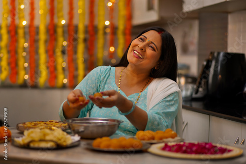 Indian woman  making Ladoo on the occasion of Diwali photo