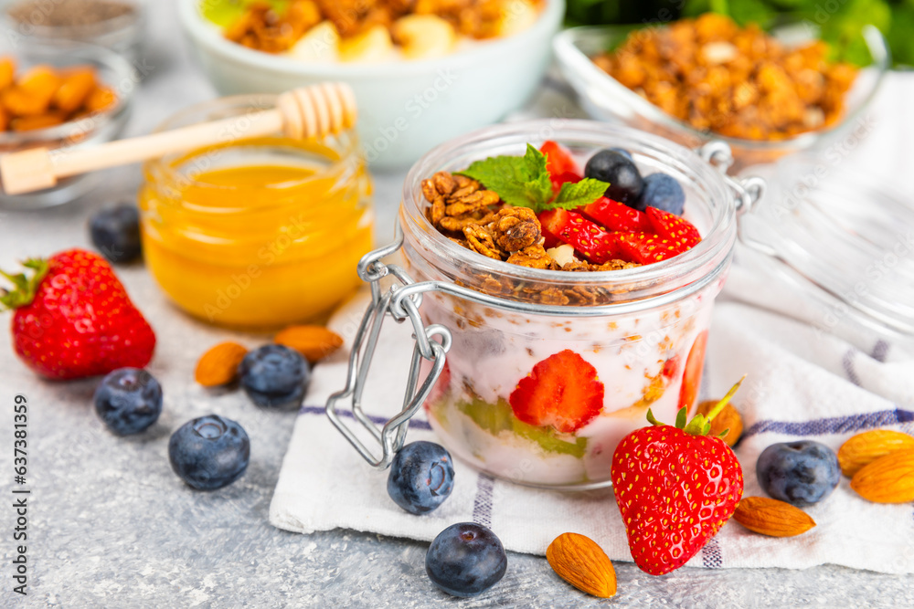 Bowl of granola with yogurt and fresh berries on a texture table. Yogurt berries, acai bowl, spirulina bowl. Healthy food, balanced breakfast. Strawberries, blueberries, kiwi, peach, almonds and chia. Bowl of granola with yogurt and fresh berries on a texture table. Yogurt berries, acai bowl, spirulina bowl. Healthy food, balanced breakfast. Strawberries, blueberries, kiwi, peach, almonds and chia.