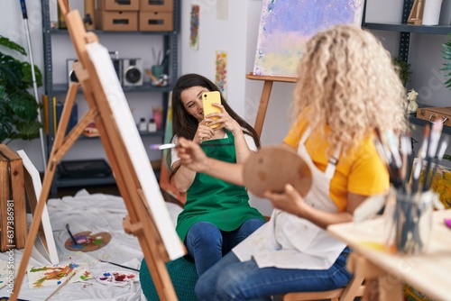 Two women artists make photo by smartphone drawing at art studio