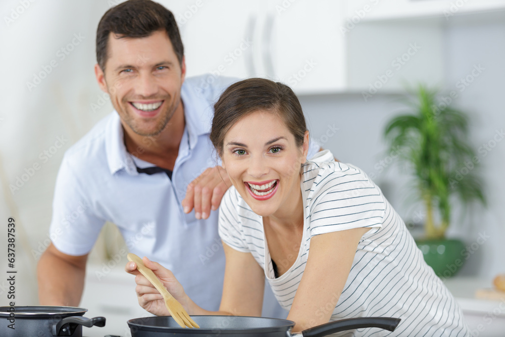 young attractive couple of man and woman cooking together young attractive couple of man and woman cooking together
