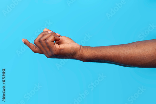 come here. african american male hand calls and beckons on blue isolated background
