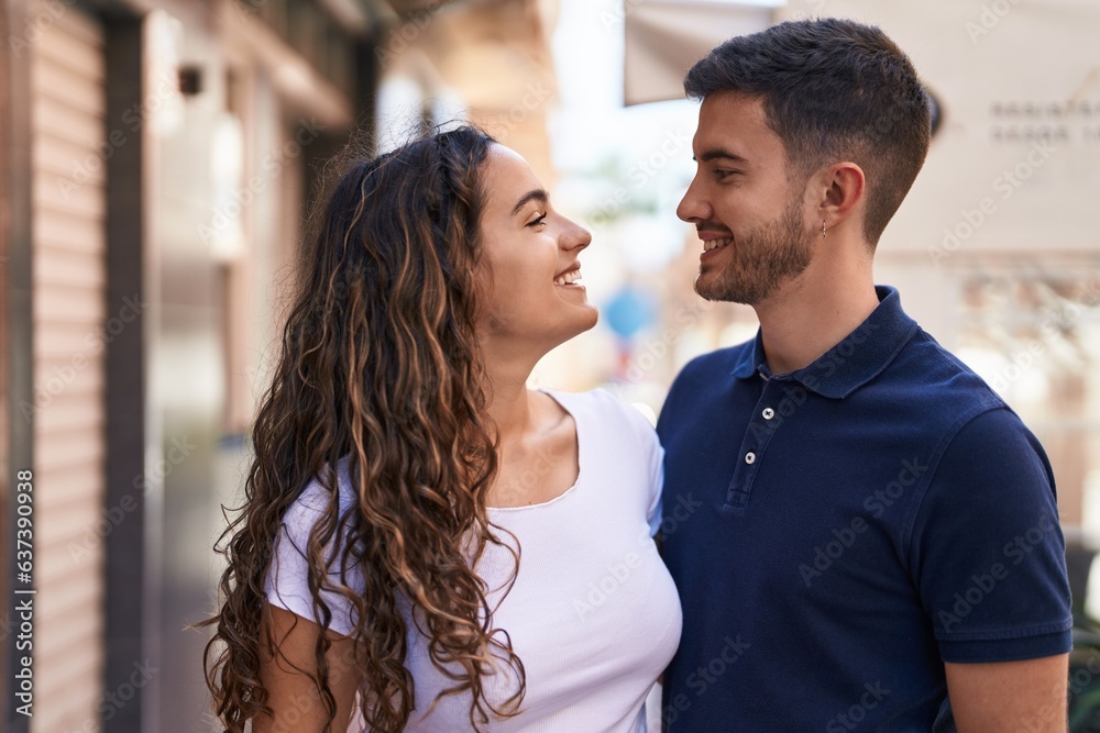 Young hispanic couple smiling confident hugging each other at street Young hispanic couple smiling confident hugging each other at street