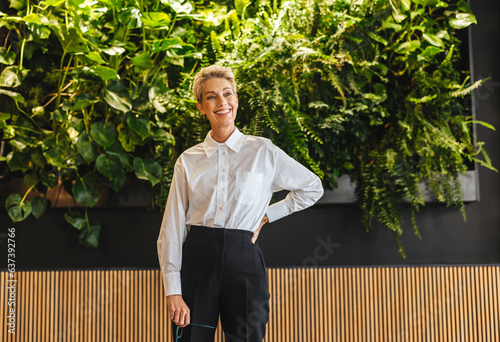 Confident and mature business woman standing in a sustainable business office photo