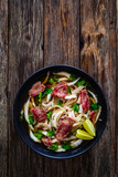 Pho soup - Vietnamese soup with beef on wooden table

