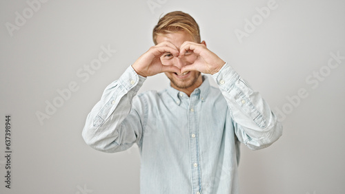 Young caucasian man smiling confident doing heart gesture with hands over isolated white background