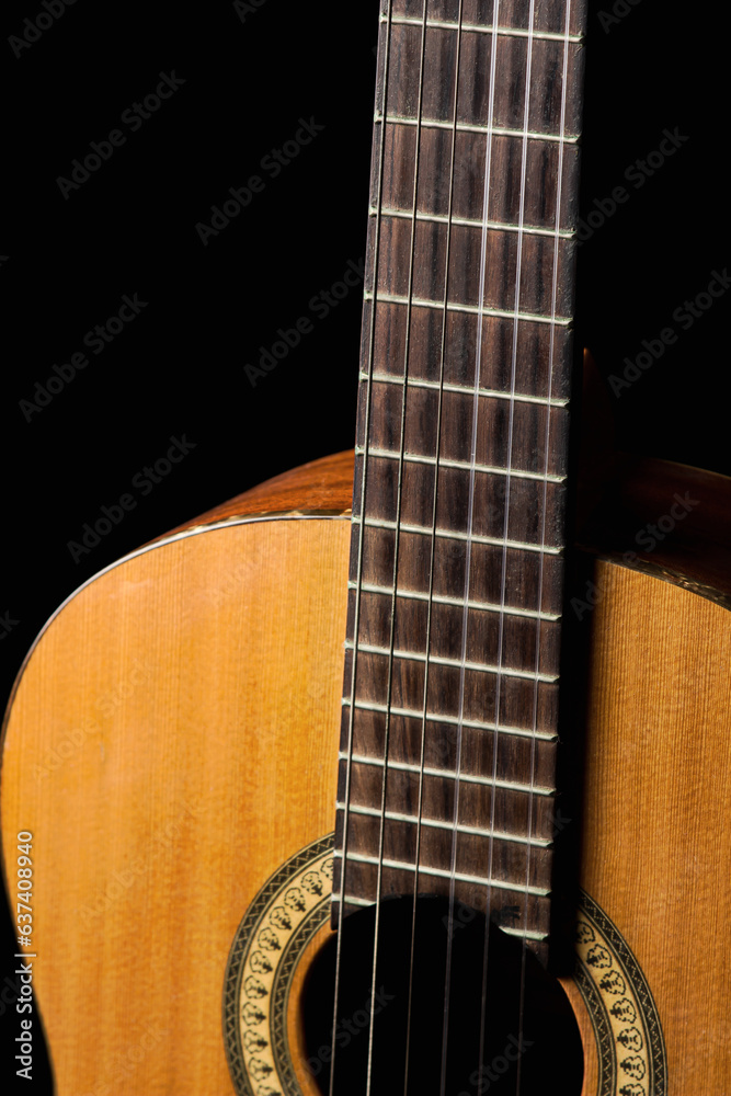 Acoustic guitar on a black background. Musical instrument