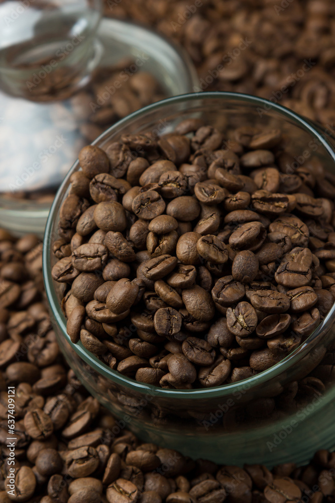 Fototapeta premium Coffee beans in a glass jar on a black background