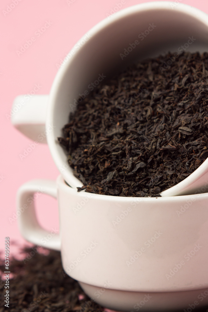 Loose tea in a white cup on a pink background Loose tea in a white cup on a pink background
