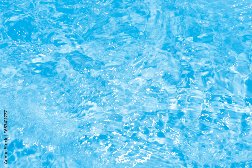 Blue water with ripples on the surface. Defocus blurred transparent blue colored clear calm water surface texture with splashes and bubbles. Water waves with shining pattern texture background.