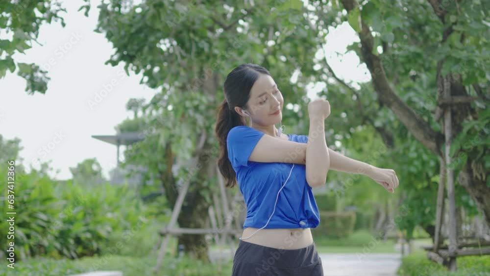 Strong athletic asian woman stretching warming up before running. Fit sport girl stretching her body warm up before workout outdoor. The girl in sportswear exercises outside for health and wellbeing Strong athletic asian woman stretching warming up before running. Fit sport girl stretching her body warm up before workout outdoor. The girl in sportswear exercises outside for health and wellbeing