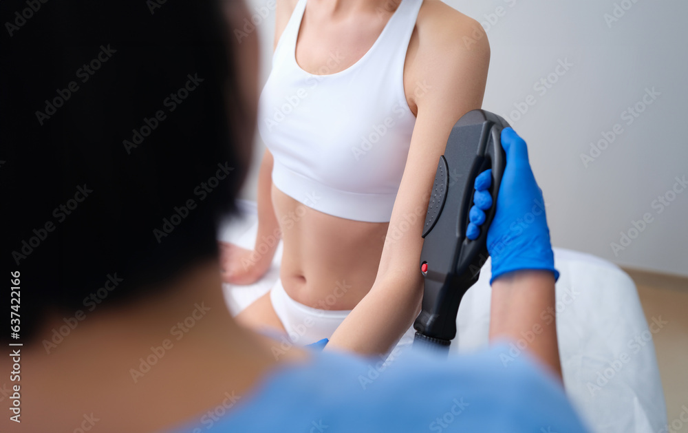 Girl is sitting in cosmetologist office, cosmetologist doctor removes hair on arms using laser device. Arm hair removal laser hair removal Girl is sitting in cosmetologist office, cosmetologist doctor removes hair on arms using laser device. Arm hair removal laser hair removal