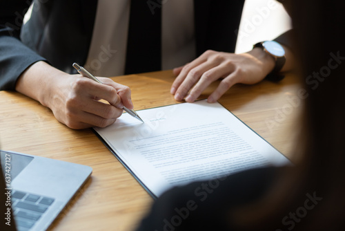 Lawyer is explaining the terms of the legal contract document and asking the client to sign it properly. Legal counsel and legal proceedings consulting services.