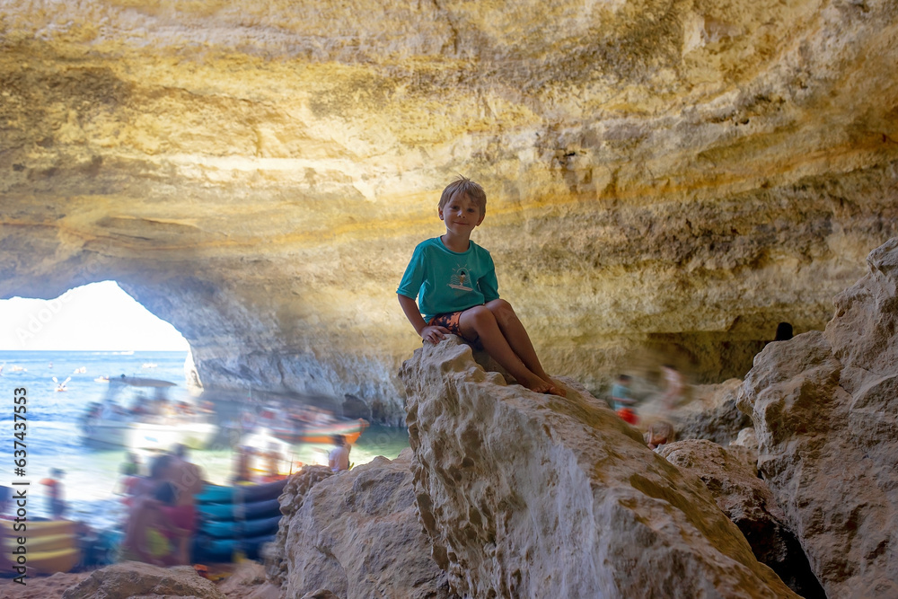 Children, enjoying Benagil, Portugal. Benagil Cave inside Algar de Benagil, famous sea cave in Algarve coast, Lagoa.