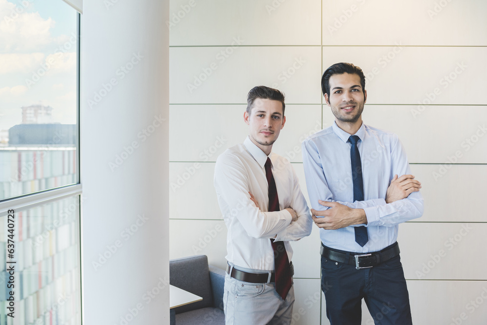 Two multiethnic businessman posing arms crossed Two multiethnic businessman posing arms crossed