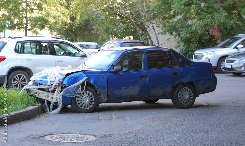A broken blue car is parked in the parking lot, Bolshevikov Avenue, St. Petersburg, Russia, August 21, 2023