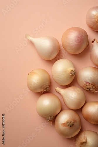 Onions on pink background. Overhead view.