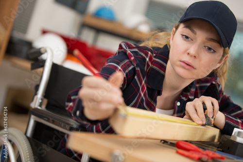 young disabled girl working in a carpentry workshop