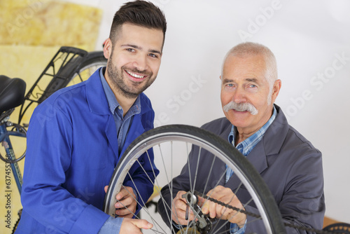 bicycle trainee mechanic and master working on mountain bike