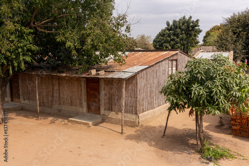 Exterior view of a reed house, common in some parts of Africa, with reed walls and zinc sheet roof