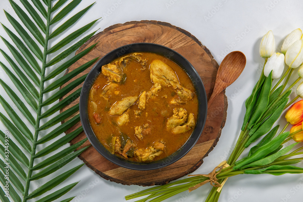 Chicken curry or masala or country chicken kuzhambu Tamilnadu style , chicken curry using fried coconut oil in traditional way and decorated in white bowl. Main dish for rice, chapati and paratha...