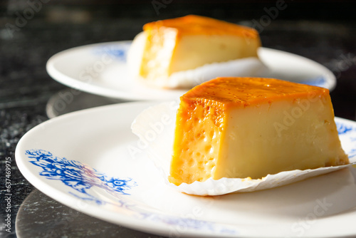 pudim or pudding, two slices of pudding on a white plate, delicious gourmet. also known as flan photo