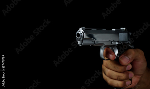 Obraz na płótnie Male hand holding a gun on black background