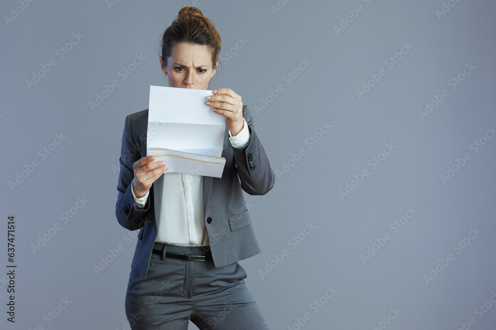 modern 40 years old woman worker against gray background modern 40 years old woman worker against gray background