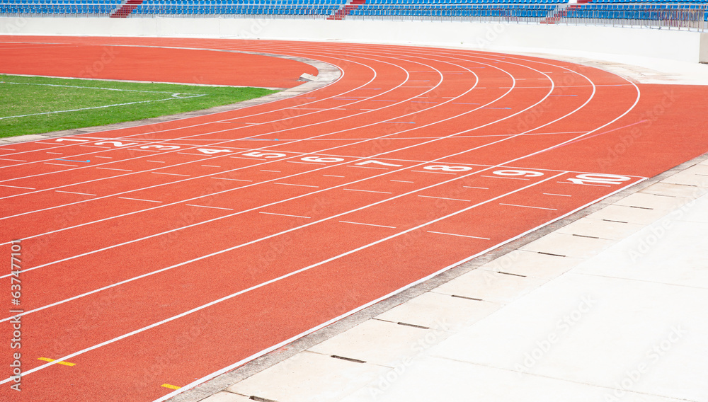 Red running track in outdoor sports stadium