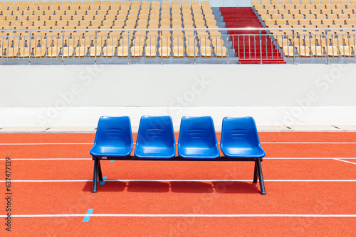 Blue reserve chair bench for staff, coach, substitutes players bench in outdoors sport stadium photo