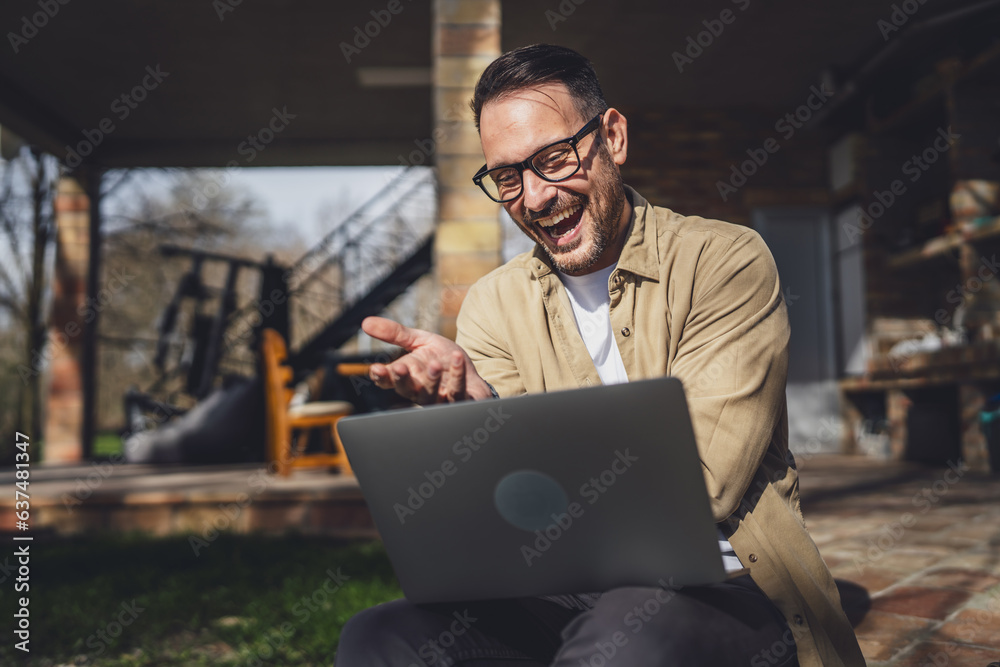 man caucasian work on laptop computer on terrace happy smile success