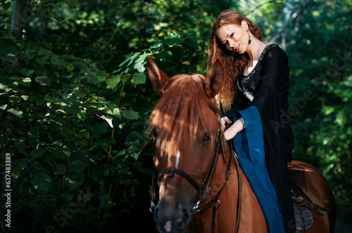Portrait of young beautiful woman riding brown horse © luengo_ua