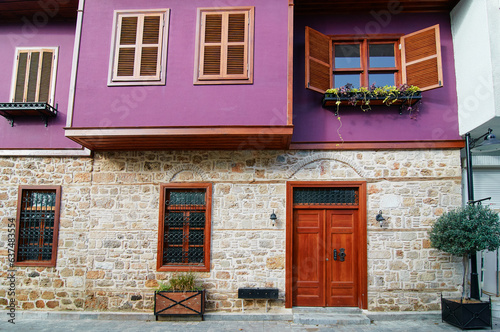 Purple old building with wooden vintage door and windows. © luengo_ua