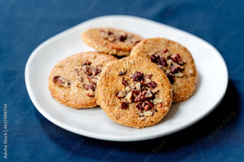 White plate with walnut cookies - side view White plate with walnut cookies - side view