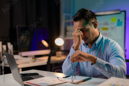 Asian businessman or employee feels like going crazy after hard work and overtime. Asian Male employee who is stressed and tired from working overtime late at night.
