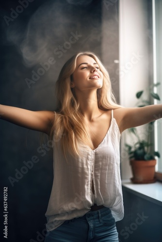 shot of an attractive young woman standing with her arms outstretched indoors © primopiano