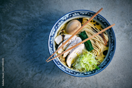 Tasty ramen with noodles and chicken fillet slices in bowl