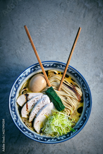 Tasty ramen with chicken fillet pieces and food sticks