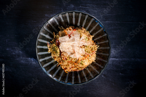 Delicious dish of rice in bowl served on black table