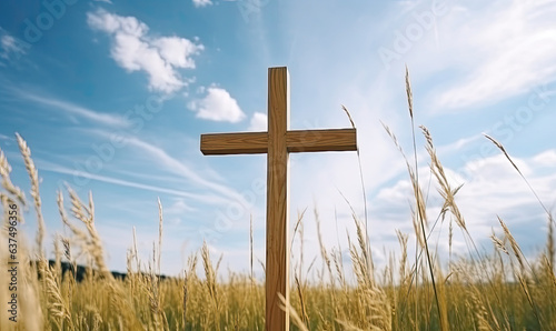 hand made wooden cross in a grassy field with a blue sky in background