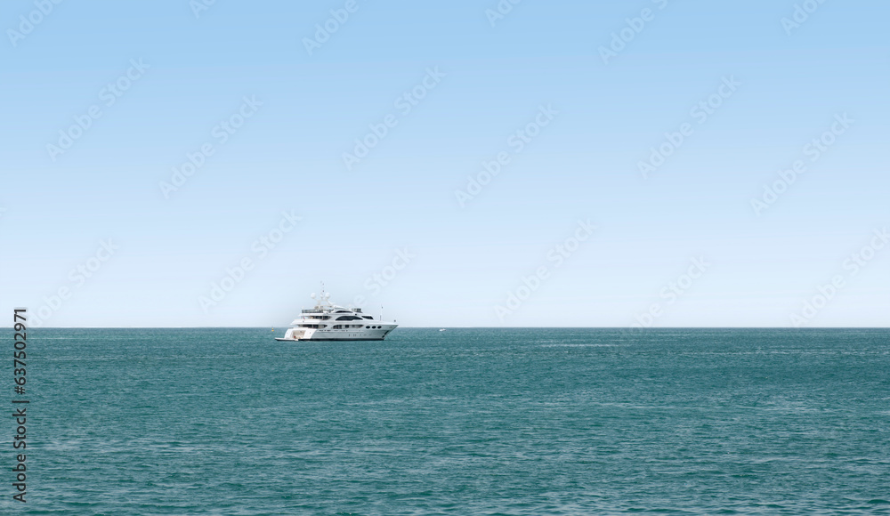 Yacht with calm seas and blue skies, with large copy space for text, titles or any other graphic elements